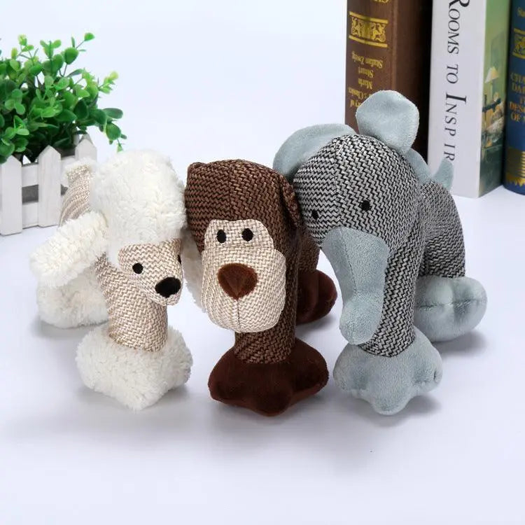 Set of three Whistle Pals interactive plush dog toys in beige, brown, and gray with built-in whistles for biting fun
