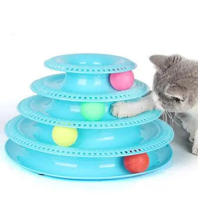 Cat playing with a blue interactive cat ball tower toy with four colorful balls on multiple circular tracks