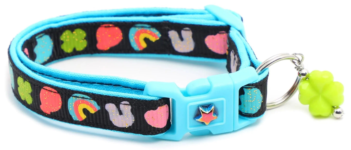 Cereal Marshmallows Breakaway Collar for cats with reinforced cotton and safety breakaway clasp, decorated with colorful cereal designs and a removable green charm.