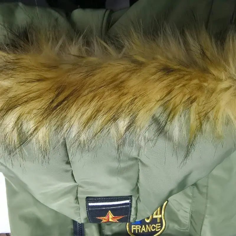 Close-up of army green Cozy Canine Cotton Jacket hood with faux fur trim and embroidered patch