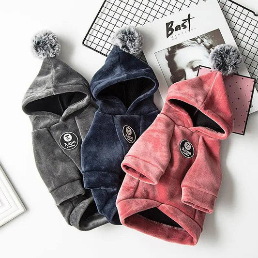 Cozy pet hoodies in grey, navy, and red with pom-poms, soft fabric for warmth and style